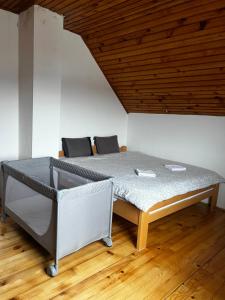 a bed in a room with a wooden ceiling at Panorama Residence Ivan in Pljevlja