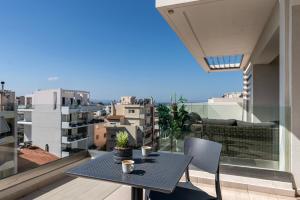 a table on a balcony with a view of a city at Athenean Oasis in Ellinikon in Athens