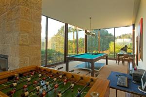 a room with a ping pong table and toy figures at GuestReady - Tranquillity in Baião in Baião