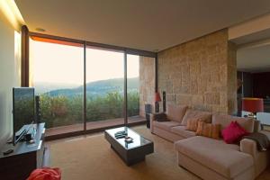 a living room with a couch and a table at GuestReady - Tranquillity in Baião in Baião