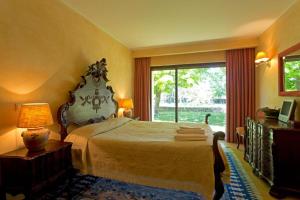 a bedroom with a large bed and a large window at GuestReady - Tranquillity in Baião in Baião +27 photos