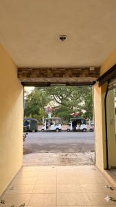 an open door to a parking lot with cars parked at Posada Azeneth in Oxkutzcab