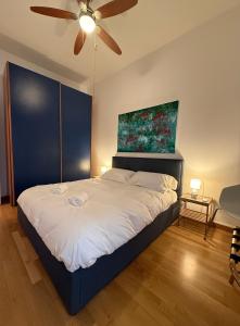 a bedroom with a bed with a painting on the wall at I Maltesi apartment in Sassari
