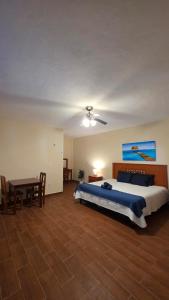 a large bedroom with a bed and a table at Casita Maya Bacalar in Bacalar