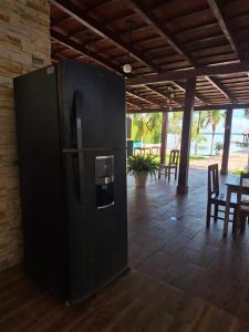 a black refrigerator in a room with a table at Casita Maya Bacalar in Bacalar