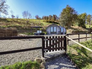 a fence in front of a gazebo at Lili Wen Fach in Ruthin