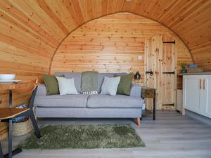 a couch in a room with a wooden ceiling at Lili Wen Fach in Ruthin