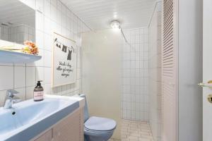 a white bathroom with a toilet and a sink at AE318-Marstal-Faergestraede-45 in Marstal +15 photos