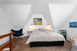 a bedroom with a bed and a chair at AE318-Marstal-Faergestraede-45 in Marstal