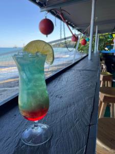 a colorful drink in a glass sitting on a table at Burica Camping in Puerto Armuelles