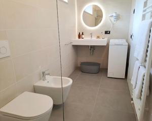 a bathroom with a toilet and a sink and a mirror at GUEST ROOM GRADONOVE in Arco