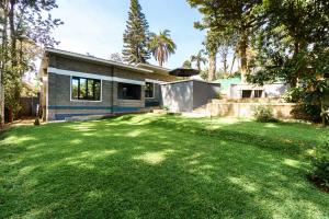 a house with a lawn in front of it at Lilac cottage in Gatunga