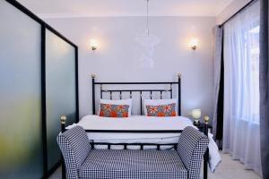 a bedroom with a bed and a chair at Lilac cottage in Gatunga