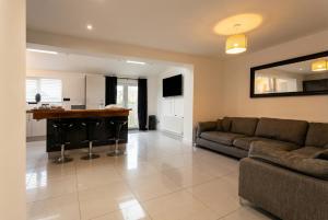 a living room with a couch and a bar at Contemporary Private Home Near Nottingham with Free Parking and Garden in Sandiacre