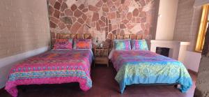 two beds sitting next to each other in a room at Sandy Shores Cabaña 5 in La Paz