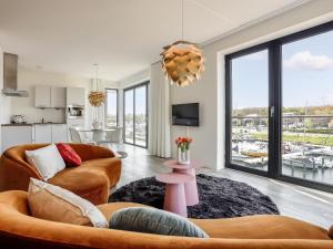 a living room with a couch and a table at Marina Vista in Kamperland
