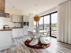 a kitchen with a table and chairs in a room at Marina Vista in Kamperland