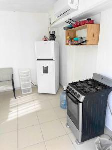 a kitchen with a stove and a refrigerator at Margaritas in Cancún