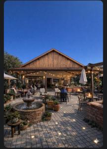 a patio with a fountain and people sitting at tables at CasaMora in Edremit