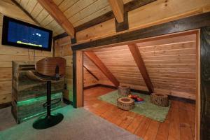 a room in a cabin with a television and a table at Makin' Memories cabin in Sevierville