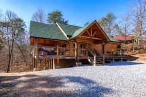 a large log cabin with a large porch and a deck at Makin' Memories cabin in Sevierville