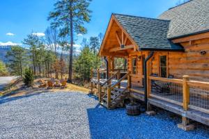 a log cabin with a staircase leading to a porch at Makin' Memories cabin in Sevierville