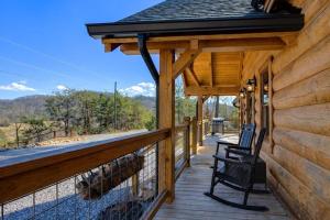 a porch of a cabin with a chair on it at Makin' Memories cabin in Sevierville