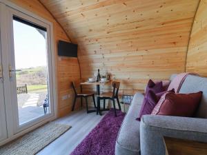 a living room with a couch and a table at Cennin Pedr in Ruthin
