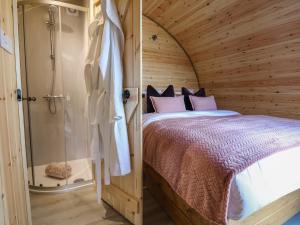 a bedroom with a large bed and a shower at Cennin Pedr in Ruthin