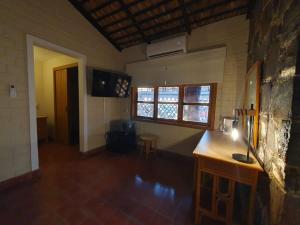 a living room with a table and two windows at Sandy Shores Cabaña 4 in La Paz +33 photos