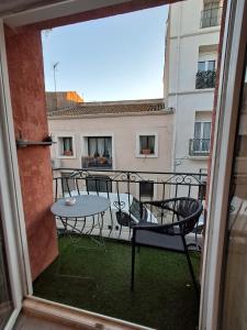 a view of a balcony with a table and chairs at Locmeze in Mèze