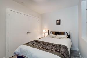 a white bedroom with a bed and a closet at Quiet Suites Up to 8 Guests Near DTVan Monthly Option in West Vancouver
