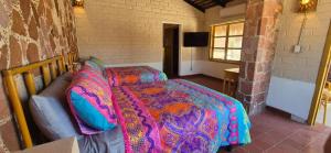 a bedroom with two beds and a couch and a window at Sandy Shores Cabaña 7 in La Paz
