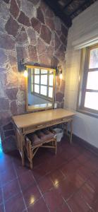 a bathroom with a wooden vanity with a mirror at Sandy Shores Cabaña 7 in La Paz