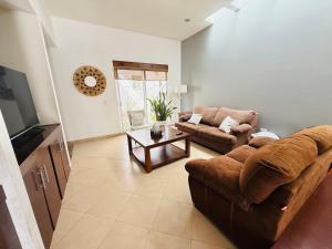 a living room with a couch and a table at Casa Ejecutiva Acogedora Impecable AGS in Aguascalientes