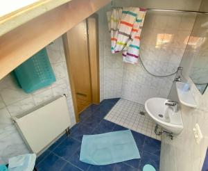 a small bathroom with a sink and a toilet at Appartementhaus Marion in Bad Bayersoien