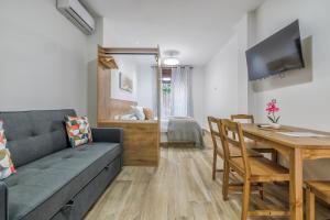 a living room with a couch and a table at Apartamentos Toril in Córdoba