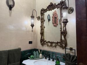 a bathroom with a sink and a mirror on the wall at Riad Xula Boutique Hotel in Puerto Peñasco