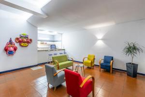 a waiting room with colorful chairs and a table at HI Ovar - Pousada de Juventude in Ovar