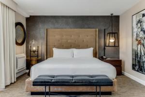 a bedroom with a large white bed and a large headboard at Revere Hotel Boston Common in Boston +82 photos