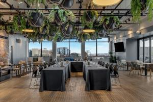 a conference room with tables and chairs and large windows at Revere Hotel Boston Common in Boston