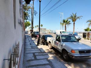 a car parked on the side of a street at Sandy Shores Cabaña 8 in La Paz
