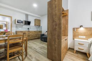 a kitchen and living room with a table and a dining room at Apartamentos Toril in Córdoba +53 photos