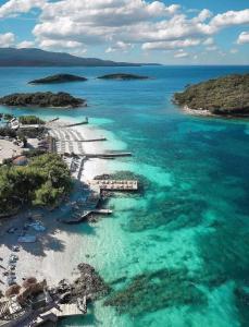 an aerial view of a beach with blue water at Vila La Familia in Ksamil
