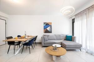 a living room with a couch and a table at Athenean Oasis in Ellinikon in Athens