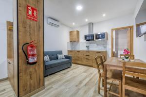 a living room with a table and a dining room at Apartamentos Toril in Córdoba