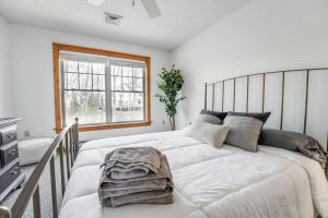 a bedroom with a large white bed and a window at A Blind Camelback Mtn views 2m to slopes in Tannersville +46 photos