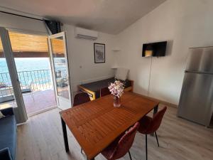 a kitchen with a table with a vase of flowers on it at Résidence Punta paliagi in Calcatoggio