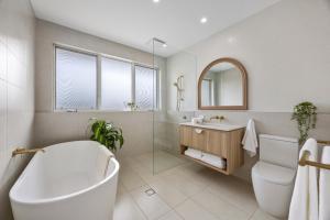 a bathroom with a tub and a toilet and a sink at Sunset Hideaway in Marino in Marino +12 photos