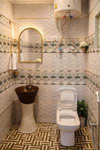 a bathroom with a sink and a toilet at Lake side stays in Srinagar +48 photos